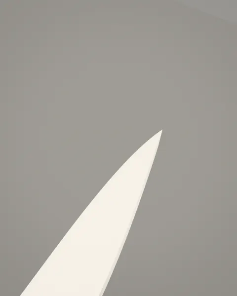 A close view of the zirconia blade’s tip and edge, lit from the side.