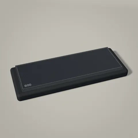 A dark diamond sharpening plate on a graphite rubber base, the 600 grit side up.